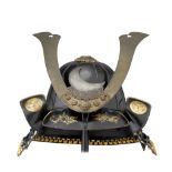A JAPANESE HELMET (KABUTO) with twelve-piece ribbed black lacquered skull, fitted with mabezashi