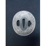 A JAPANESE SWORD GUARD (TSUBA) of iron with kozuka hitsu-ana and kogai hitsu-ana, with silver