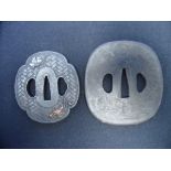 TWO JAPANESE SWORD GUARDS (TSUBA) of iron, the first of mokko gata form with kozuka hitsu-ana and