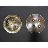 TWO INDIAN SMALL SHIELDS (DHAL), 18TH AND 19TH CENTURIES the first of hide, the interior painted red