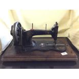 An early 20th century hand sewing machine in case