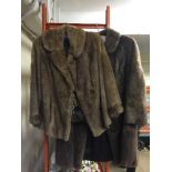 Two lady's fur coats