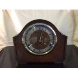 An oak cased mantel clock with pendulum