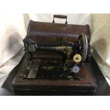 A cased Singer hand sewing machine