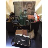 A box of vintage Valet razor, lighter, antique glass bottles, flat iron,