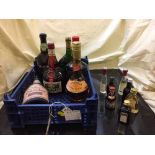 A box of a bottle of Gran marnier, bottle of La Peyrouse Armagnac, port, Tia Maria,