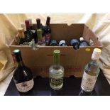 A box of approximately fifteen bottles of wine and two bottles of kirsch