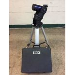 A Meade EXT Astro telescope with carry box on stand and accessories