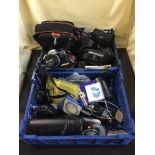 Two baskets of assorted cameras and equipment - Olympus OM10 camera with lens,