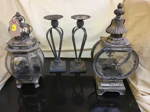 A pair of metal candle holders and a two decorative carriage lamps