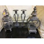 A pair of metal candle holders and a two decorative carriage lamps