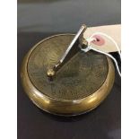 A brass Gilbert pocket sun dial and compass