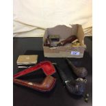 A box of assorted pipes, lighters, match box holder,