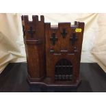 A late 19th century oak correspondence cabinet modelled as a castle