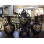 A late 19th century three piece decorative blue and gilt vase set with classical decoration