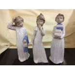 Three Nao figures - children in night dress