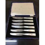 A set of six cased sterling silver and mother of pearl handled butter knives