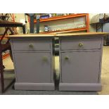 A pair of painted teak topped bedside cabinets