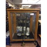 A set of chemist's scales, in glazed display case.