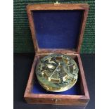 A brass ship's compass in mahogany and brass inlaid box