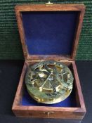 A brass ship's compass in mahogany and brass inlaid box