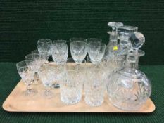 A tray of three glass decanters with stoppers, lead crystal glasses,