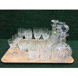 A tray of three glass decanters with stoppers, lead crystal glasses,