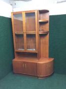 A teak G-plan glazed door bookcase together with a matching corner cabinet