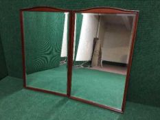 A pair of mahogany framed Stag bevelled mirrors