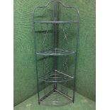 A metal four tier folding corner stand