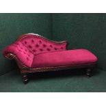 A Victorian chaise longue in burgundy buttoned fabric