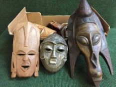 A box of tribal wall masks (Q)