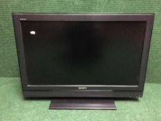 A Sony Bravia 32 inch LCD TV with instructions and remote