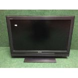 A Sony Bravia 32 inch LCD TV with instructions and remote