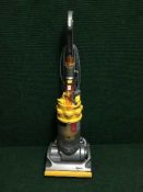 A Dyson DC 14 upright vac cleaner and two rugs