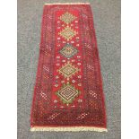 A Persian fringed woolen rug,