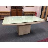 A marble dining table on pedestal base with plate glass top,