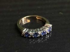 A 9ct gold sapphire and diamond half hoop ring