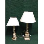 A pair of cream and gilt table lamps with floral decoration