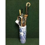 A blue and white oriental stick stand and a large quantity of walking sticks, Shepherd's crook,