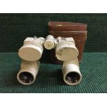 A pair of Daiichi Seimitsu Kogyo binoculars in leather case