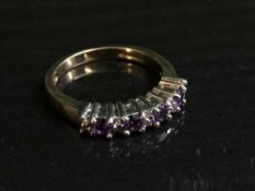 A 9ct gold amethyst and diamond half hoop ring