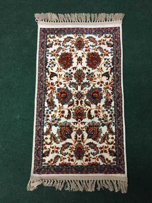 A fringed Persian rug with silk pile, 95cm by 50cm.