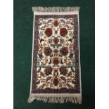 A fringed Persian rug with silk pile, 95cm by 50cm.