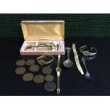 A box of crested spoon, plated pickle fork, lady's brooch,