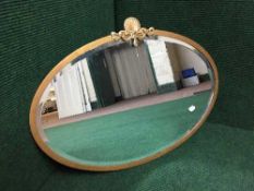 An early twentieth century oval framed bevelled mirror