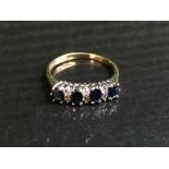 An 18ct gold sapphire and diamond half hoop ring