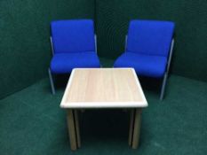 A contemporary beech reception table together with two reception chairs upholstered in blue fabric