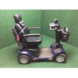 A Pride mobility scooter with keys and charger,