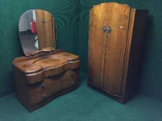 A three piece walnut bedroom suite comprising of lady's and gent's wardrobe and dressing chest